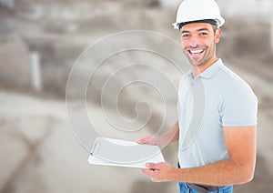 Construction Worker with chart in front of construction site