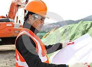 Construction worker checking blueprint