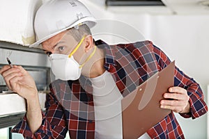 construction worker checking thermally insulating walls