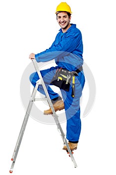 Construction worker climbing up the step ladder