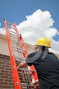 Construction Worker Climbs Ladder photo