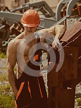 Construction worker concept. Construction worker rest at heavy machinery. Construction worker in working uniform