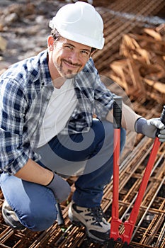 construction worker at construction site assembling falsework photo