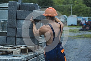Construction worker. Construction worker carry bricks. Construction worker unload truck. Construction worker in working