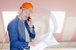 Construction worker consulting with somebody