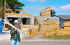 Construction worker or contractor in a hard hat working on a house construction site