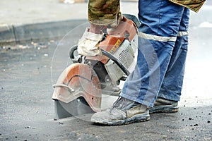 Construction worker with cut-off machine