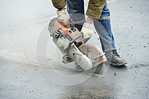 Construction worker with cut-off machine