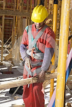 Construction Worker Cuts Board - Vertical
