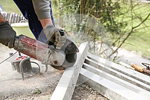 Construction worker cutting a reinforced concrete pillar