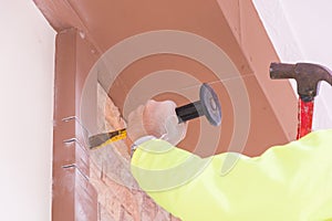 Construction worker demolishing old brick