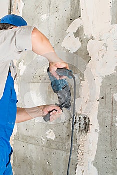 Construction worker drilling hole