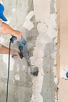 Construction worker drilling hole