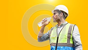 The construction worker drinks water to quench his thirst