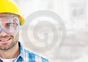 Construction Worker with eye protection goggles in front of construction site