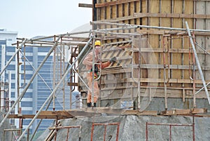 A construction worker fabricating beam formwork