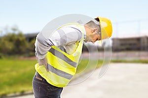 Construction worker feeling backpain in lumbar area