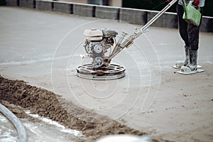 Construction worker finishing concrete screed with power trowel machine, helicopter concrete screed  finishing and smoothing