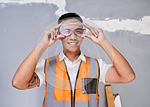 A construction worker fits his safety goggles while on site