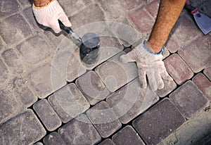 Construction worker fixing the pavestone