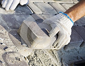 Construction worker fixing the pavestone