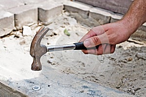 Construction worker fixing the pavestone on the roadtion worker installing stone blocks on pavement