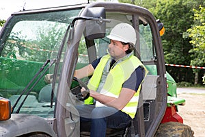 Construction worker with forklift truck