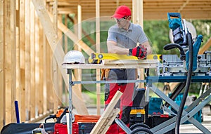 Construction Worker in Front of Newly Developed Wooden Made House photo