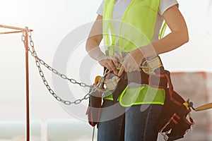 Construction worker girl fastens