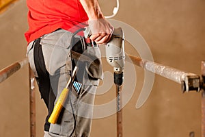 Construction worker with hand drill