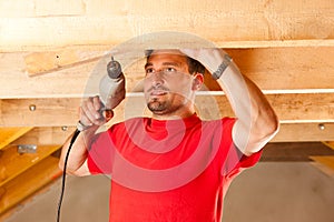 Construction worker with hand drill