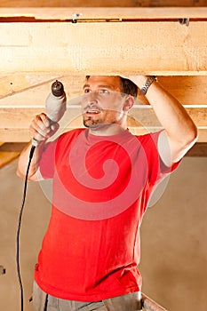 Construction worker with hand drill