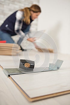 construction worker handywoman installing new wood floor at house