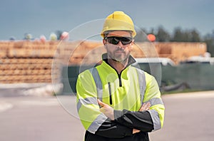 Construction worker with hardhat helmet on american construction site. Construction engineer worker in builder uniform