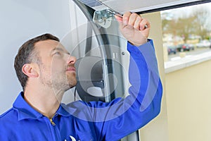 Construction worker in hardhat working on building window