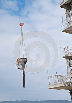 Construction Worker in a High-Rise Concrete Pouring Bucket