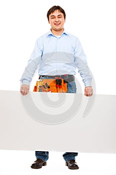 Construction worker holding blank billboard