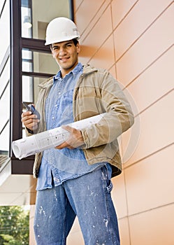 Construction worker holding cell phone