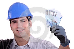 Construction worker holding money