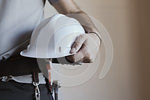 Construction worker holding a safety helmet