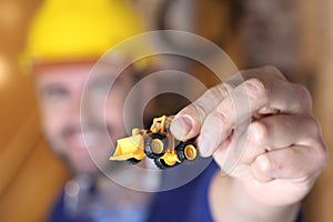 Construction worker holding small machinery