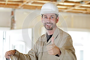 Construction worker holding thumbs up