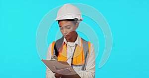 Construction worker, inspection or woman writing on checklist for architecture on blue background. Safety papers, studio