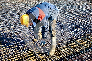 Construction worker installing binding wires