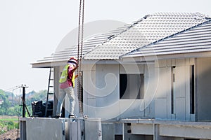 Construction worker are installing Crane hooks at the precast concrete wall, Precast house construction