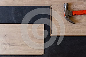 Construction worker installing laminate floor in a new renovated attic. Home improvement concept