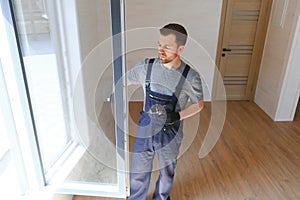 Construction worker installing new window in house