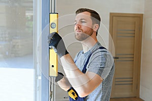 Construction worker installing new window in house