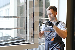 Construction worker installing new window in house