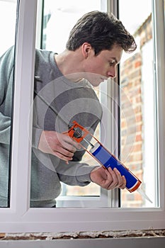 Construction Worker Installing New Windows In House